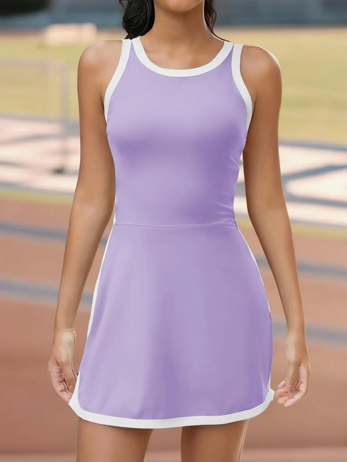 women's sleeveless halter tennis dress with white piping, open back design, and stylish cutout details at the back, perfect for sports or casual wear